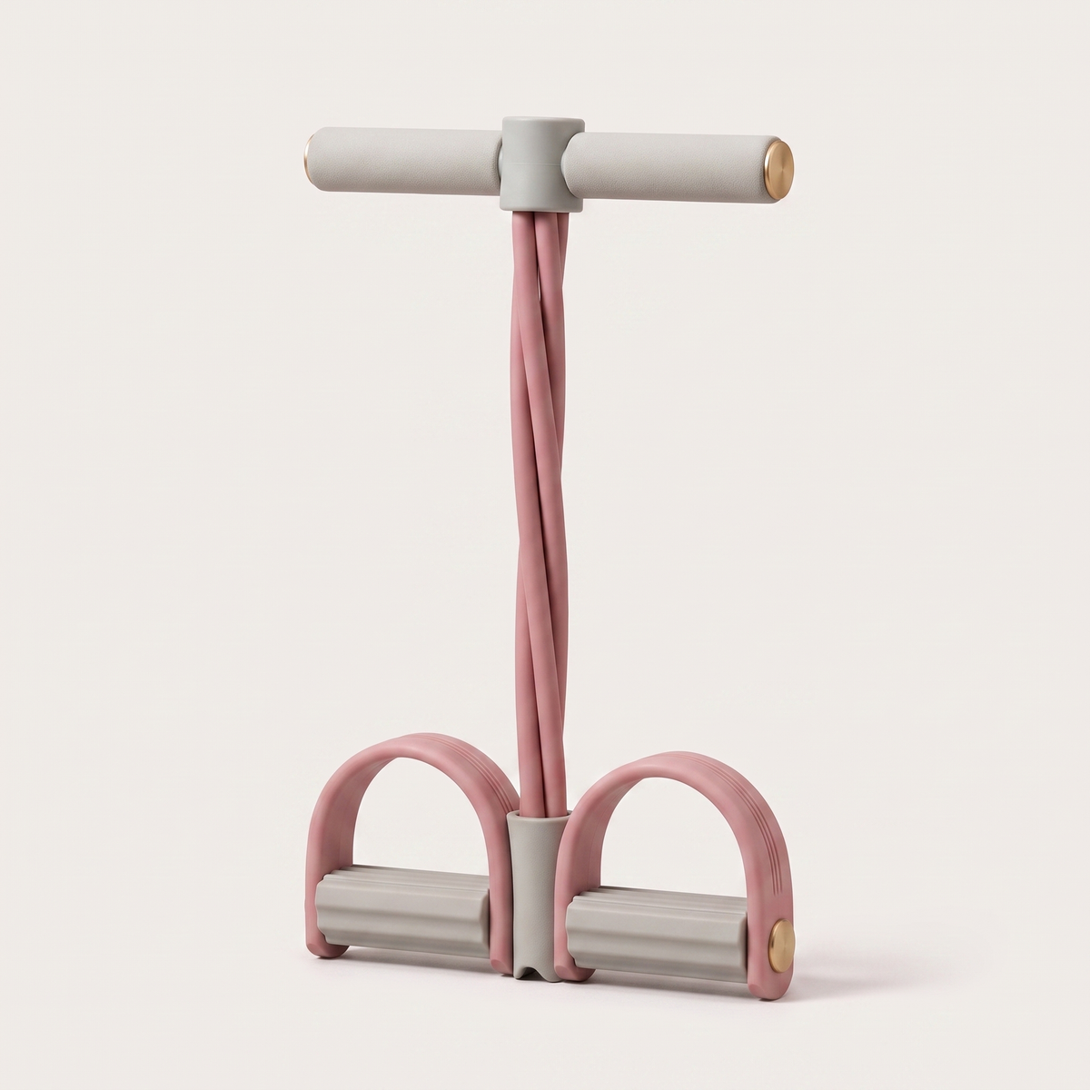 The TILVA PedalCore in Rose, standing upright on a pale background: two grey foam foot bars with brass end caps, four twisted rose resistance tubes and a grey foam handle bar